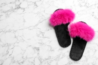 Pair of soft slippers on white marble background, flat lay. Space for text Photo of Pair of soft slippers on white marble background, flat lay. Space for text