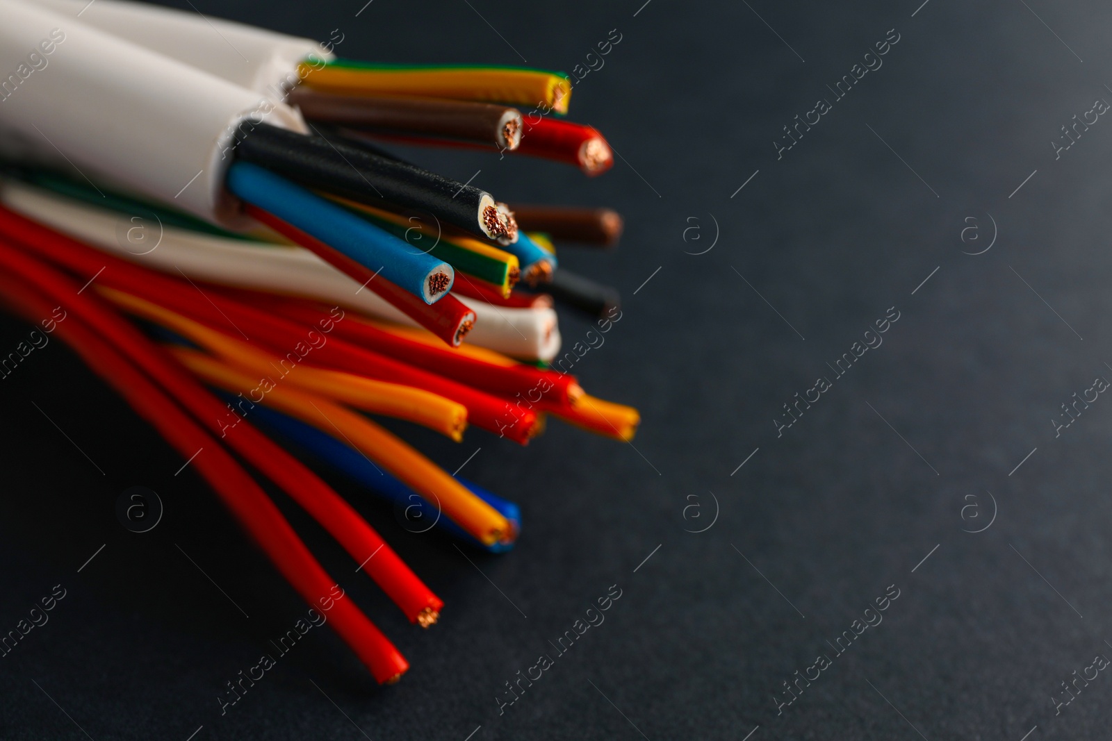 Many electrical cables on black background, closeup. Space for text Photo of Many electrical cables on black background, closeup. Space for text