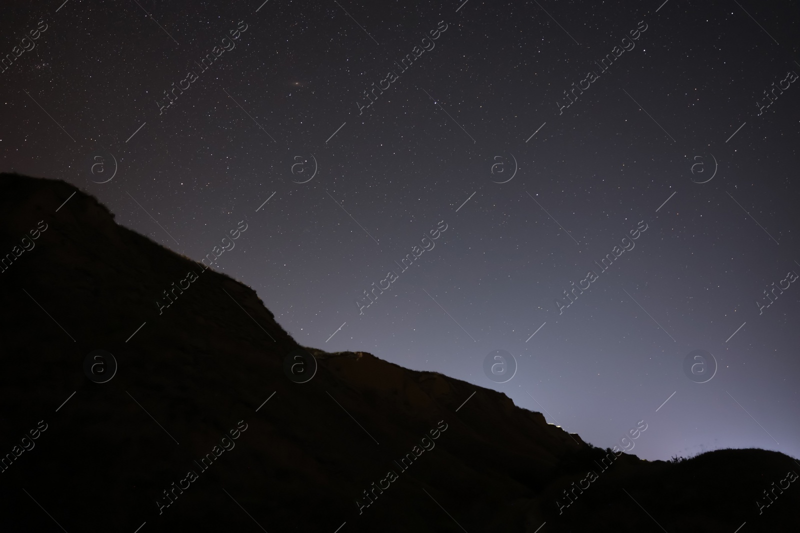 Picturesque view of starry sky at night over hill Photo of Picturesque view of starry sky at night over hill
