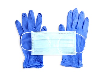 Medical gloves and protective face mask on white background, top view Photo of Medical gloves and protective face mask on white background, top view