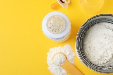 Flat lay composition with powdered infant formula on yellow background, space for text. Baby milk Photo of Flat lay composition with powdered infant formula on yellow background, space for text. Baby milk