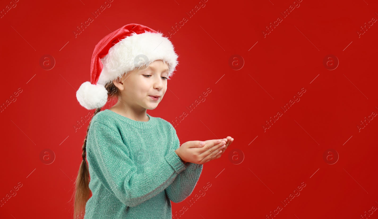 Happy little child in Santa hat on red background. Christmas celebration Image of Happy little child in Santa hat on red background. Christmas celebration