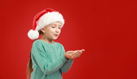 Happy little child in Santa hat on red background. Christmas celebration Image of Happy little child in Santa hat on red background. Christmas celebration