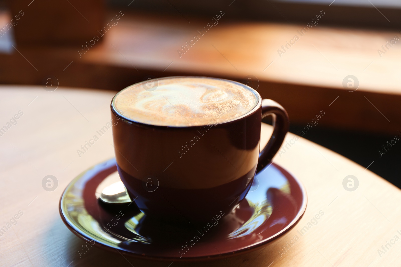 Aromatic coffee on wooden table in cafe, closeup Photo of Aromatic coffee on wooden table in cafe, closeup