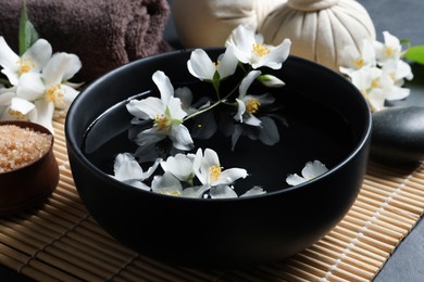Beautiful spa composition with jasmine essential oil and fresh flowers on table, closeup Photo of Beautiful spa composition with jasmine essential oil and fresh flowers on table, closeup