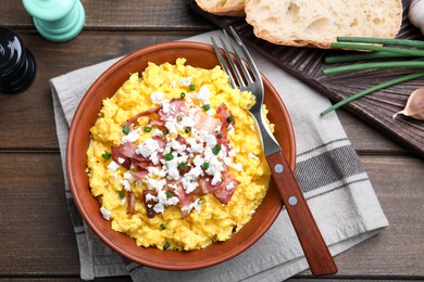 Tasty banosh served with brynza and pork cracklings on wooden table, flat lay. Traditional Ukrainian dish Photo of Tasty banosh served with brynza and pork cracklings on wooden table, flat lay. Traditional Ukrainian dish