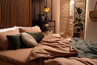 Stylish room with comfortable bed. Interior design Photo of Stylish room with comfortable bed. Interior design