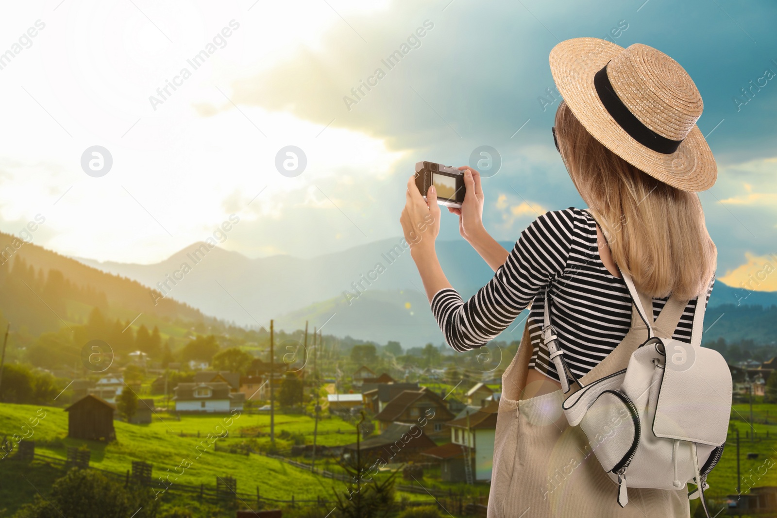 Traveler with backpack taking photo during summer vacation trip Image of Traveler with backpack taking photo during summer vacation trip
