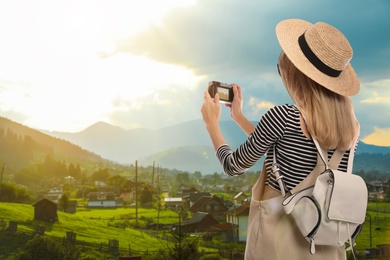 Traveler with backpack taking photo during summer vacation trip Image of Traveler with backpack taking photo during summer vacation trip