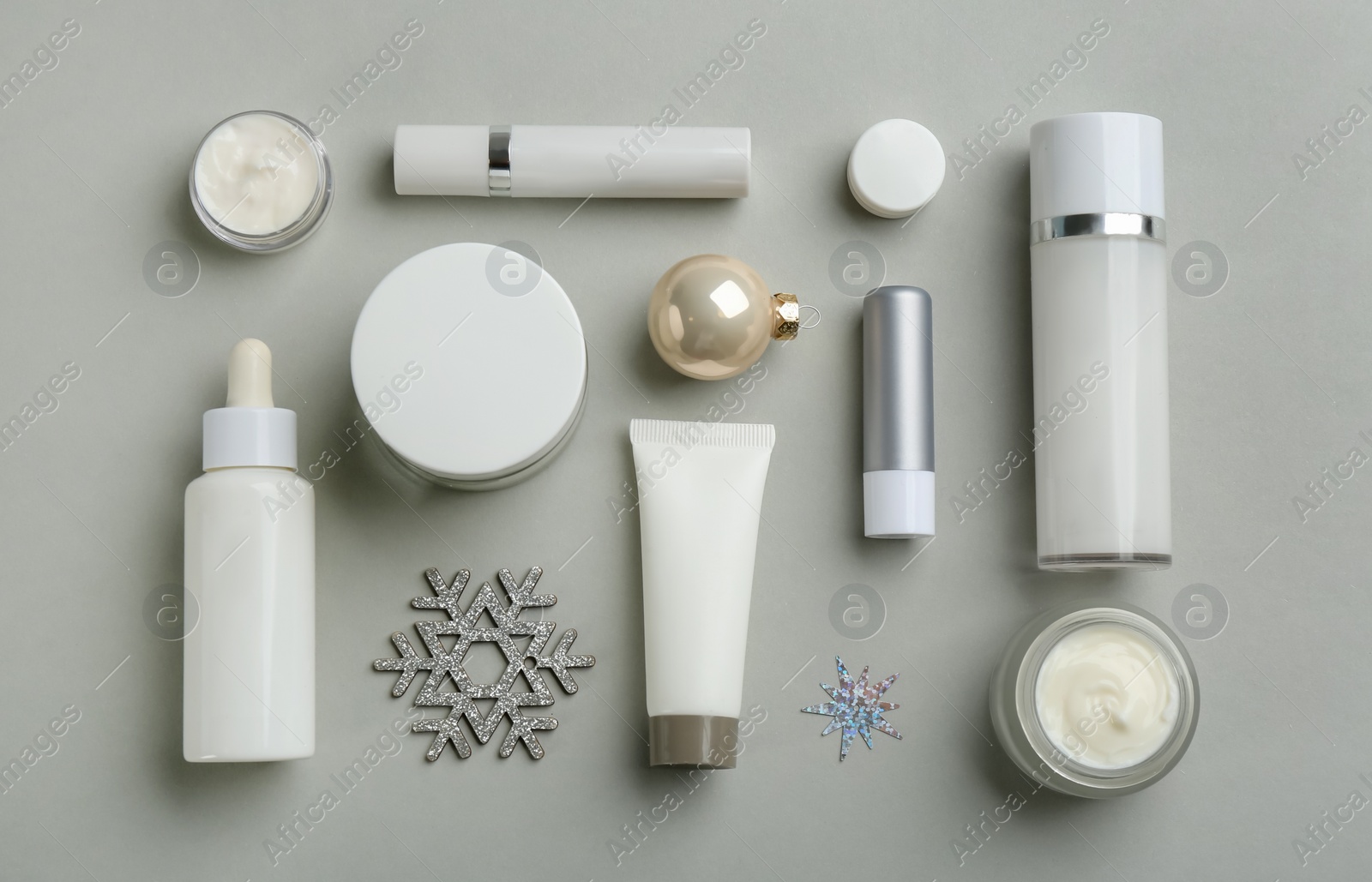 Flat lay composition with different cosmetic products on light grey background. Winter care Photo of Flat lay composition with different cosmetic products on light grey background. Winter care