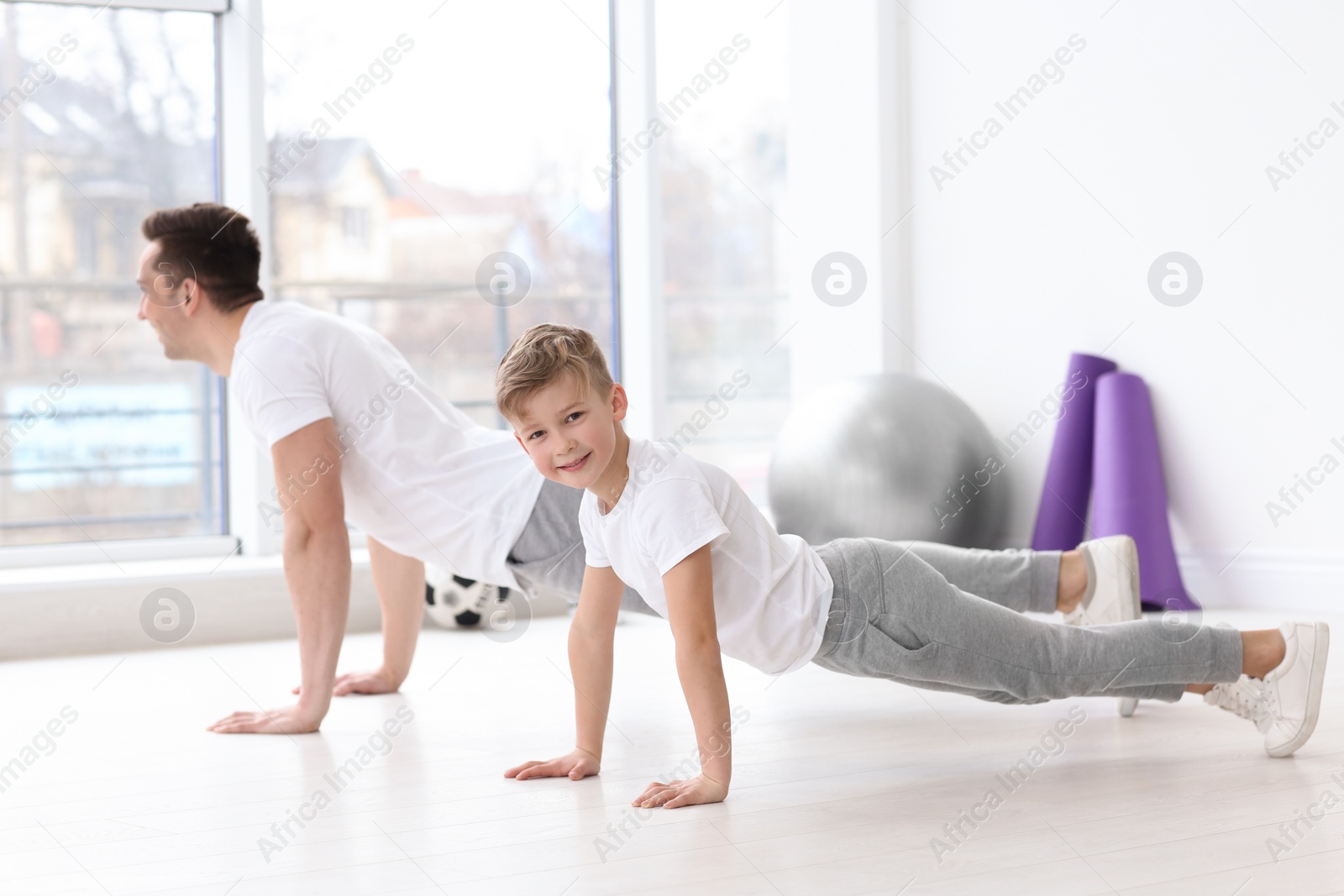 Dad and his son training in gym Photo of Dad and his son training in gym