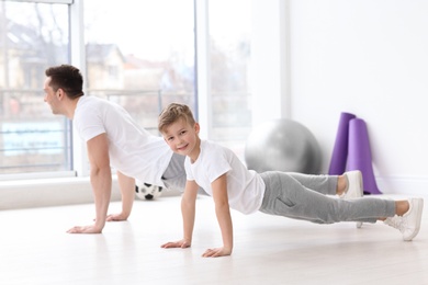 Photo of Dad and his son training in gym