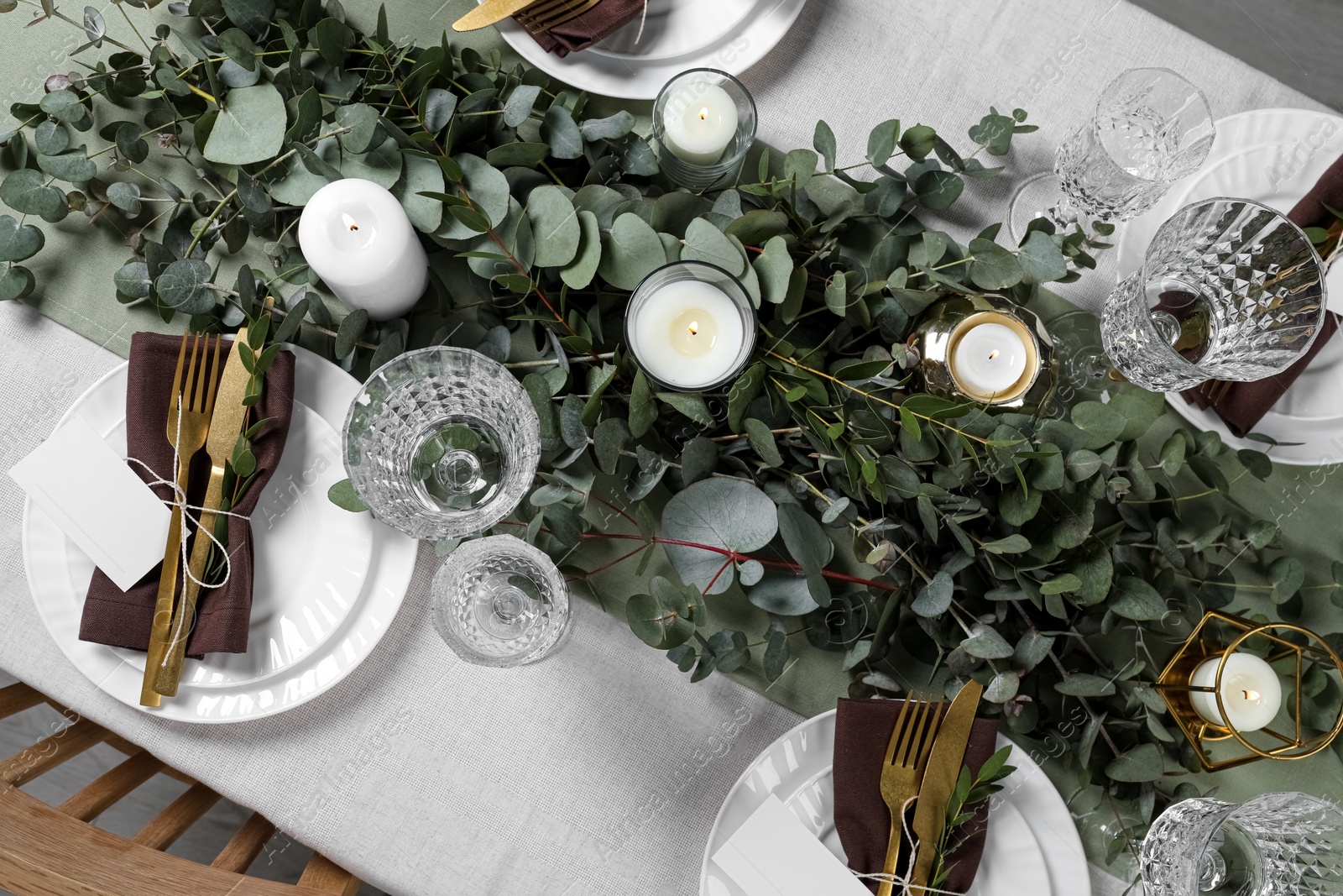Luxury table setting with beautiful decor and blank cards. Festive dinner Photo of Luxury table setting with beautiful decor and blank cards. Festive dinner