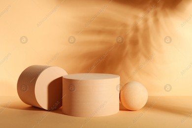 Presentation of product. Podiums and shadows on orange background. Space for text Photo of Presentation of product. Podiums and shadows on orange background. Space for text