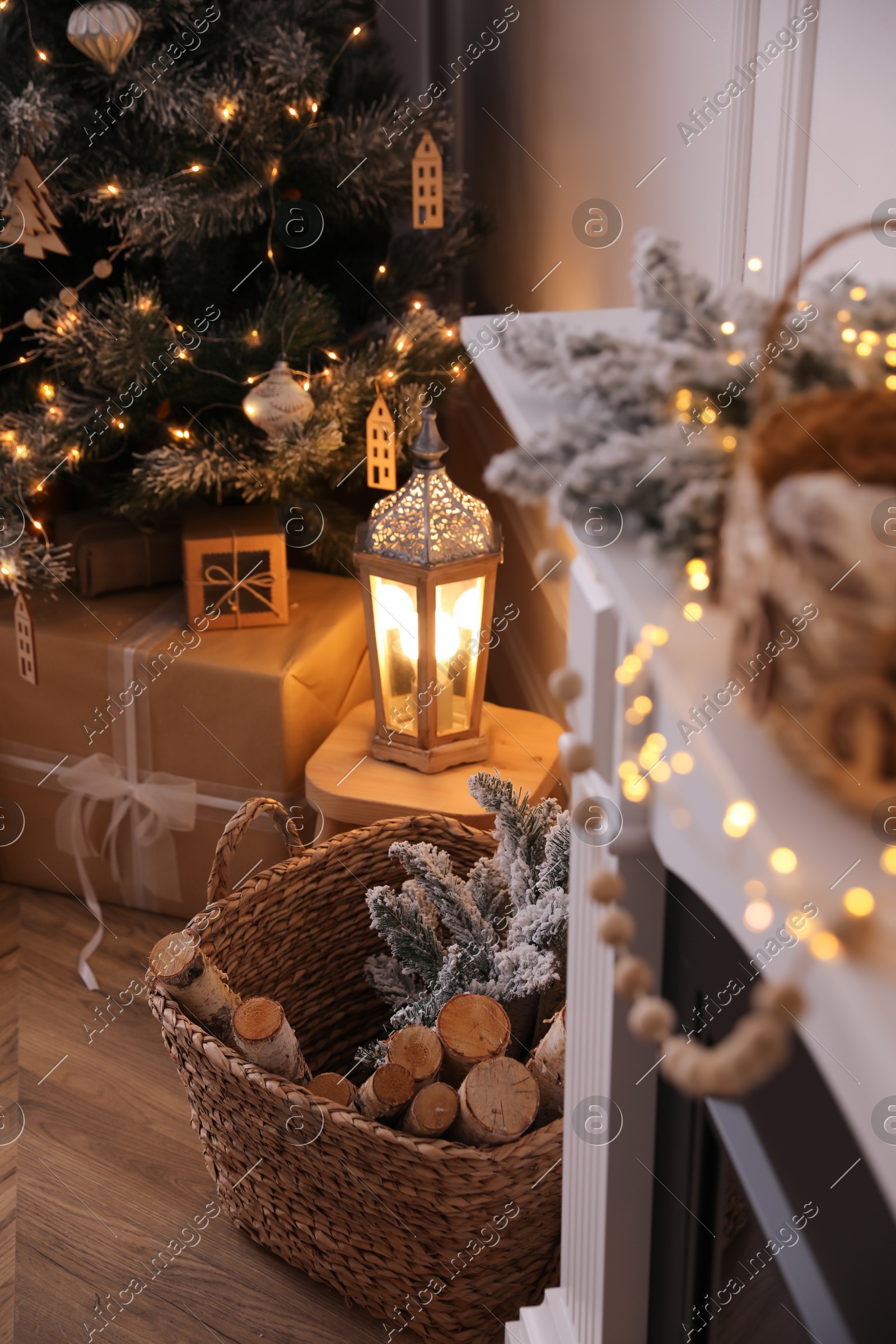 Basket with wood near fireplace and Christmas tree indoors. Interior element Photo of Basket with wood near fireplace and Christmas tree indoors. Interior element