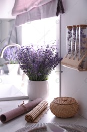 Beautiful lavender flowers on countertop near sink in kitchen Photo of Beautiful lavender flowers on countertop near sink in kitchen