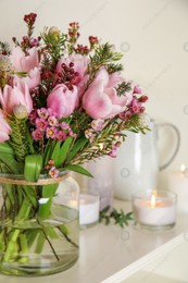 Beautiful bouquet with spring pink tulips on shelf Photo of Beautiful bouquet with spring pink tulips on shelf