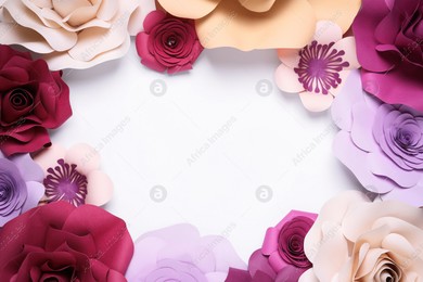 Frame of beautiful paper flowers on white background, flat lay. Space for text Photo of Frame of beautiful paper flowers on white background, flat lay. Space for text