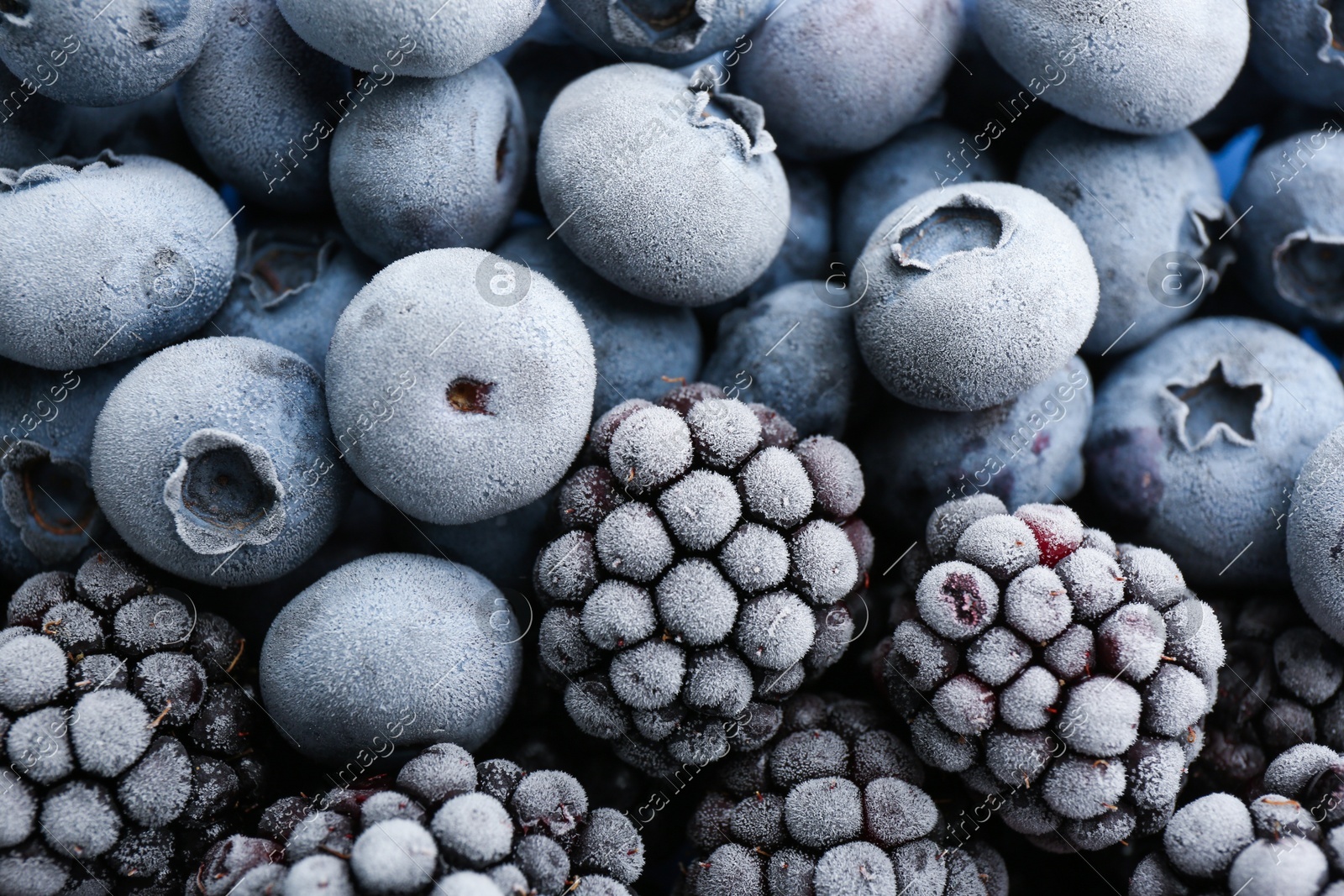 Tasty frozen blackberries and blueberries as background, top view Photo of Tasty frozen blackberries and blueberries as background, top view