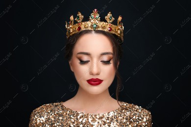 Beautiful young woman wearing luxurious crown on black background Photo of Beautiful young woman wearing luxurious crown on black background