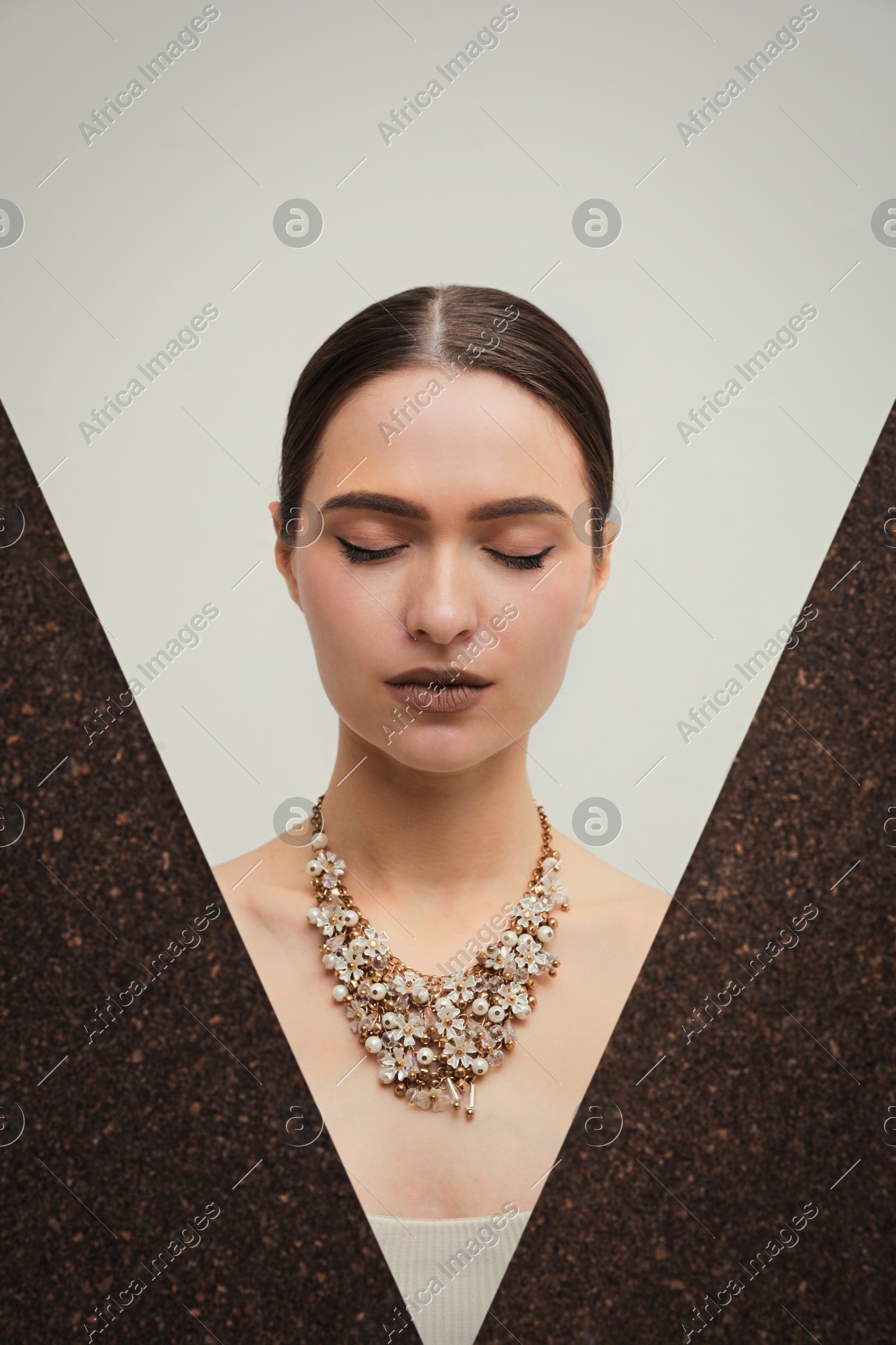 Beautiful young woman with luxury necklace posing on light background Photo of Beautiful young woman with luxury necklace posing on light background