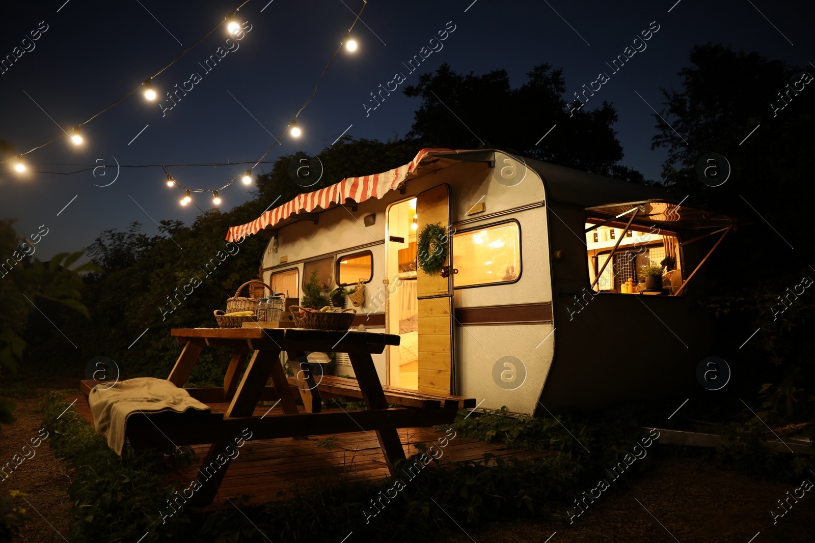 Beautiful view of motorhome outdoors at night. Summer camping Photo of Beautiful view of motorhome outdoors at night. Summer camping