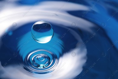 Splash of clear water with drop on blue background, closeup Photo of Splash of clear water with drop on blue background, closeup