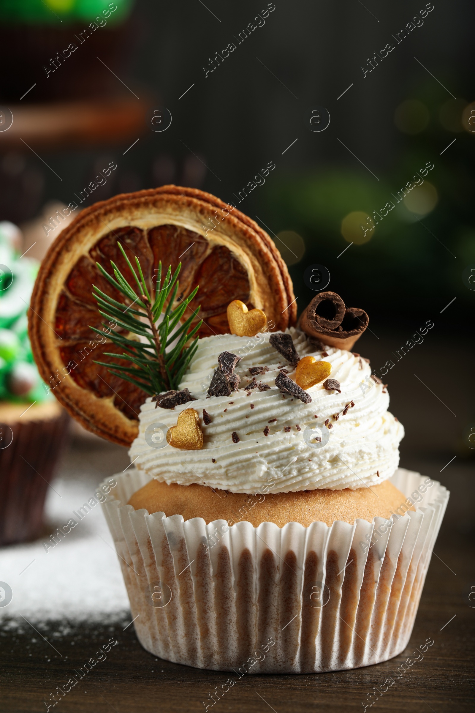 Beautifully decorated Christmas cupcake on wooden table, closeup Photo of Beautifully decorated Christmas cupcake on wooden table, closeup