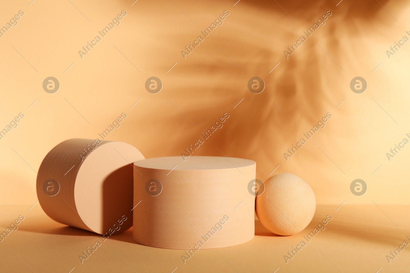 Presentation of product. Podiums and shadows on orange background. Space for text Photo of Presentation of product. Podiums and shadows on orange background. Space for text