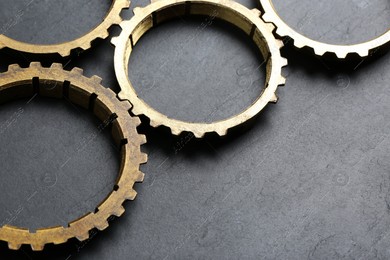 Stainless steel gears on grey background, closeup. Space for text Photo of Stainless steel gears on grey background, closeup. Space for text