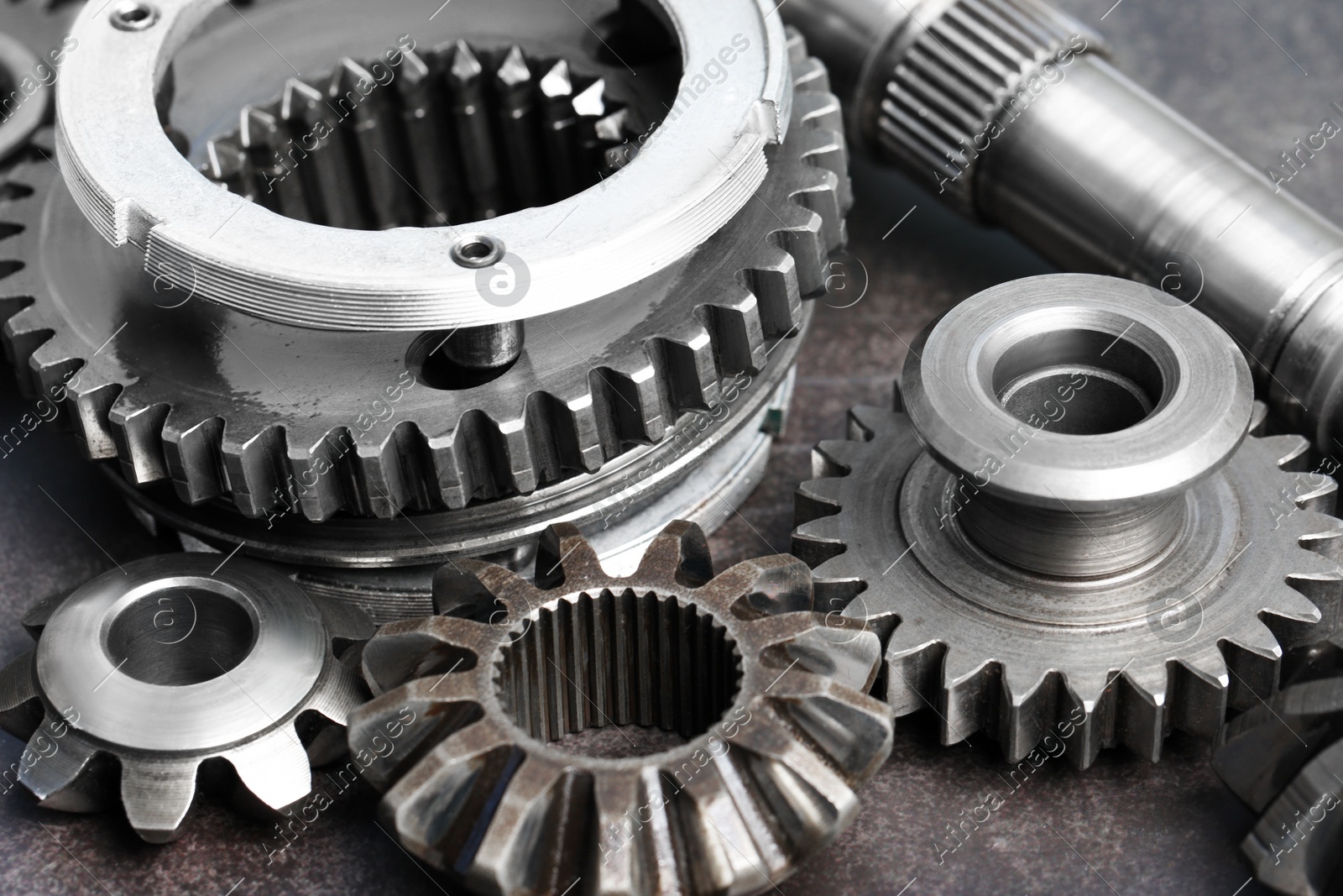 Different stainless steel gears on grey background, closeup Photo of Different stainless steel gears on grey background, closeup