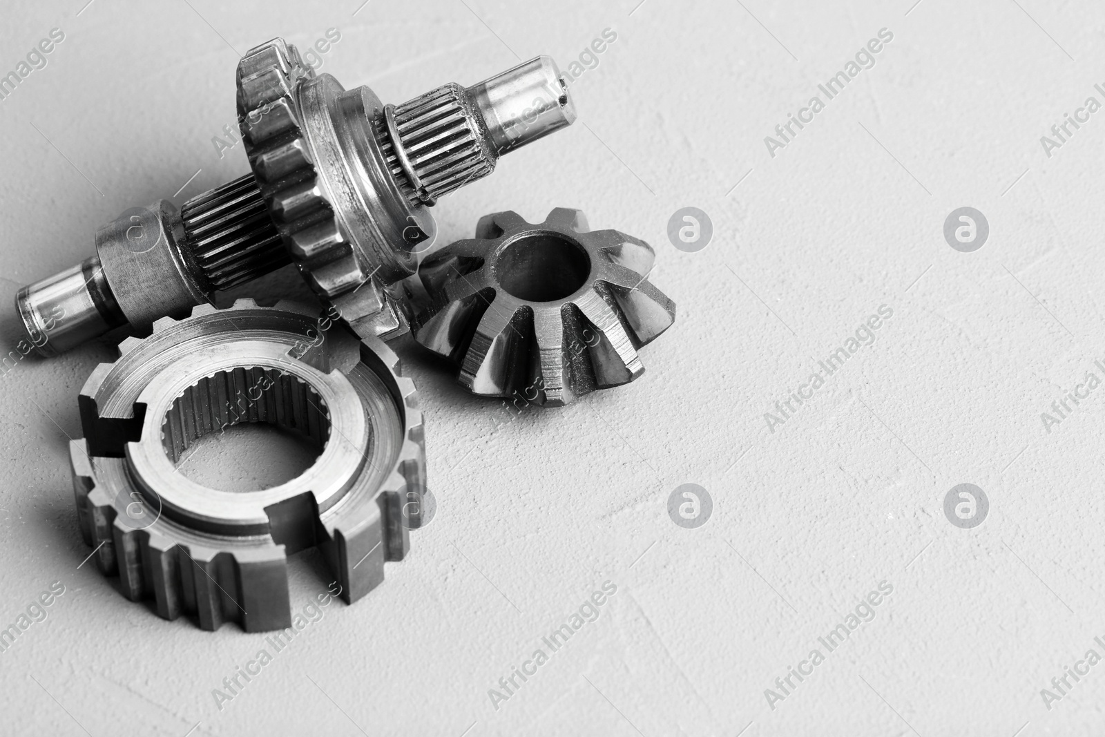 Different stainless steel gears on light grey background. Space for text Photo of Different stainless steel gears on light grey background. Space for text
