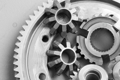 Different stainless steel gears on light grey background, top view Photo of Different stainless steel gears on light grey background, top view