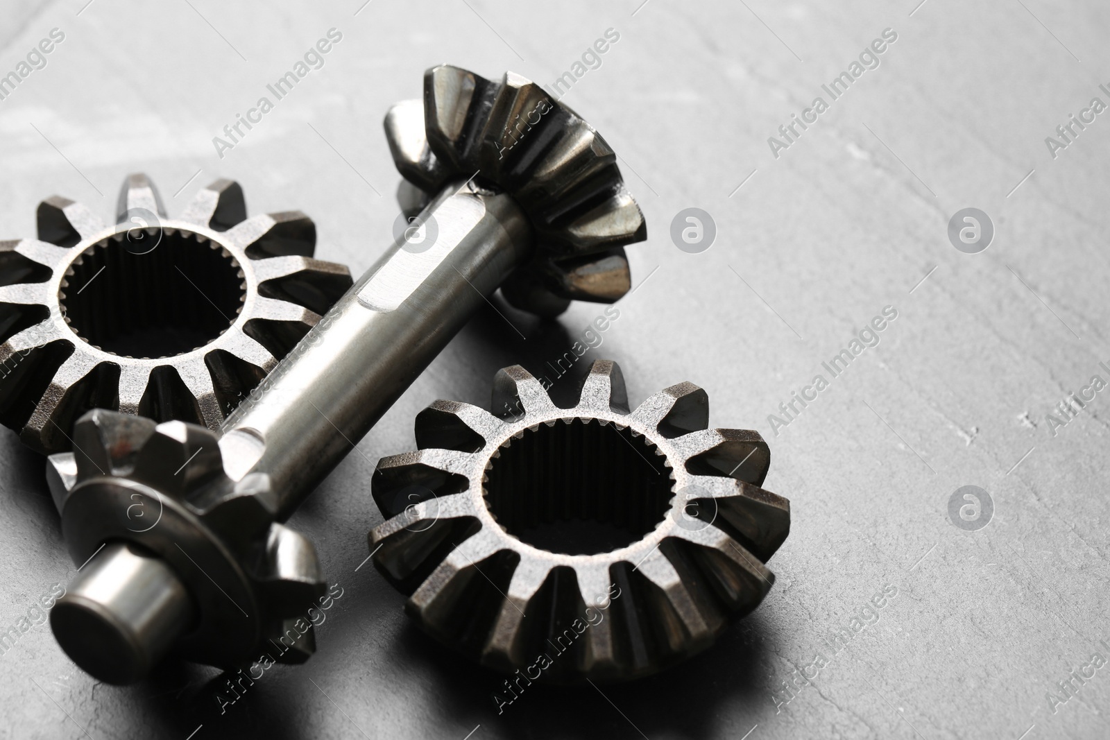 Different stainless steel gears on light grey background, closeup. Space for text Photo of Different stainless steel gears on light grey background, closeup. Space for text