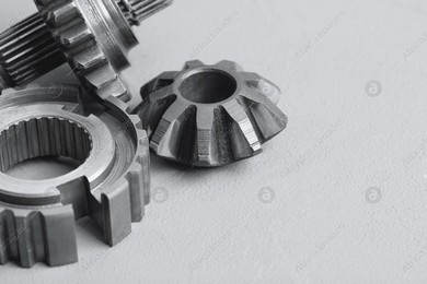 Different stainless steel gears on light grey background, closeup. Space for text Photo of Different stainless steel gears on light grey background, closeup. Space for text