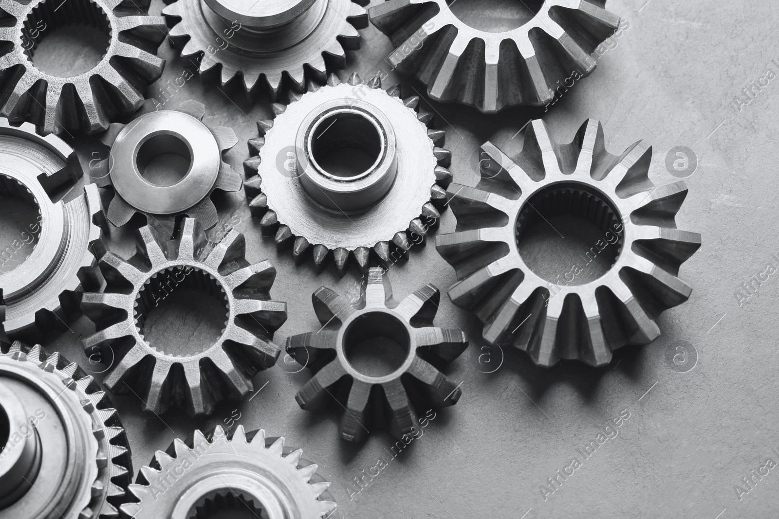 Different stainless steel gears on light grey background, above view Photo of Different stainless steel gears on light grey background, above view