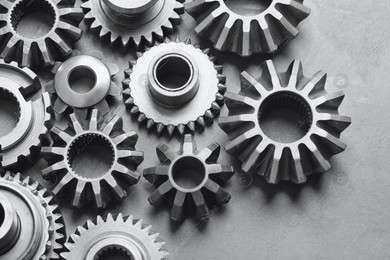 Different stainless steel gears on light grey background, above view Photo of Different stainless steel gears on light grey background, above view