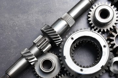 Different stainless steel gears on grey background, flat lay Photo of Different stainless steel gears on grey background, flat lay