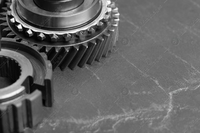 Different stainless steel gears on grey background, closeup. Space for text Photo of Different stainless steel gears on grey background, closeup. Space for text