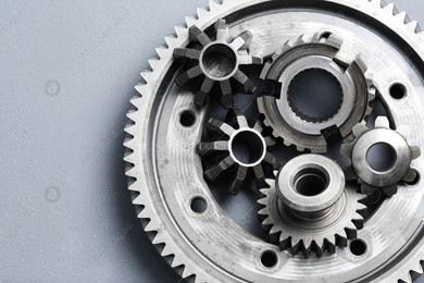 Different stainless steel gears on light grey background, top view Photo of Different stainless steel gears on light grey background, top view