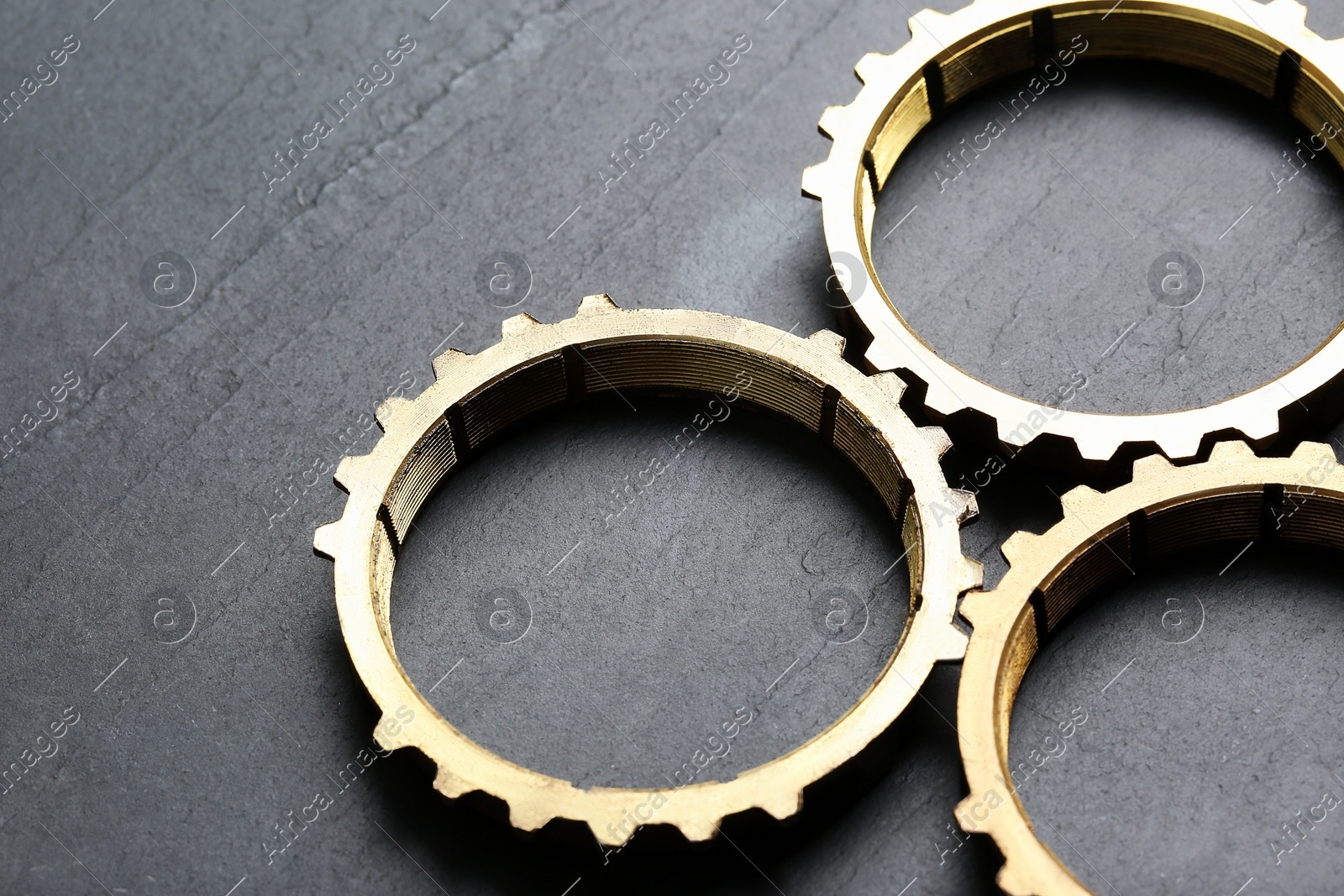 Stainless steel gears on grey background, closeup Photo of Stainless steel gears on grey background, closeup