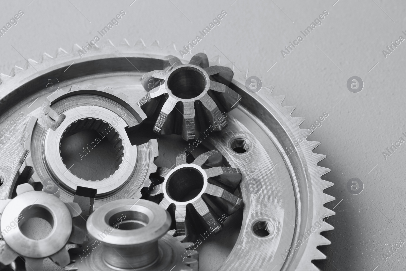 Different stainless steel gears on light grey background Photo of Different stainless steel gears on light grey background