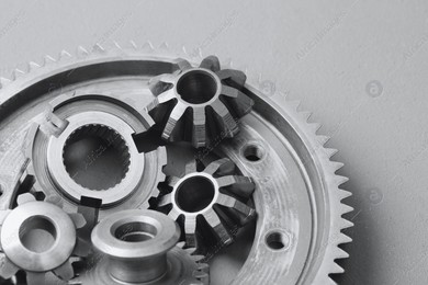 Different stainless steel gears on light grey background Photo of Different stainless steel gears on light grey background