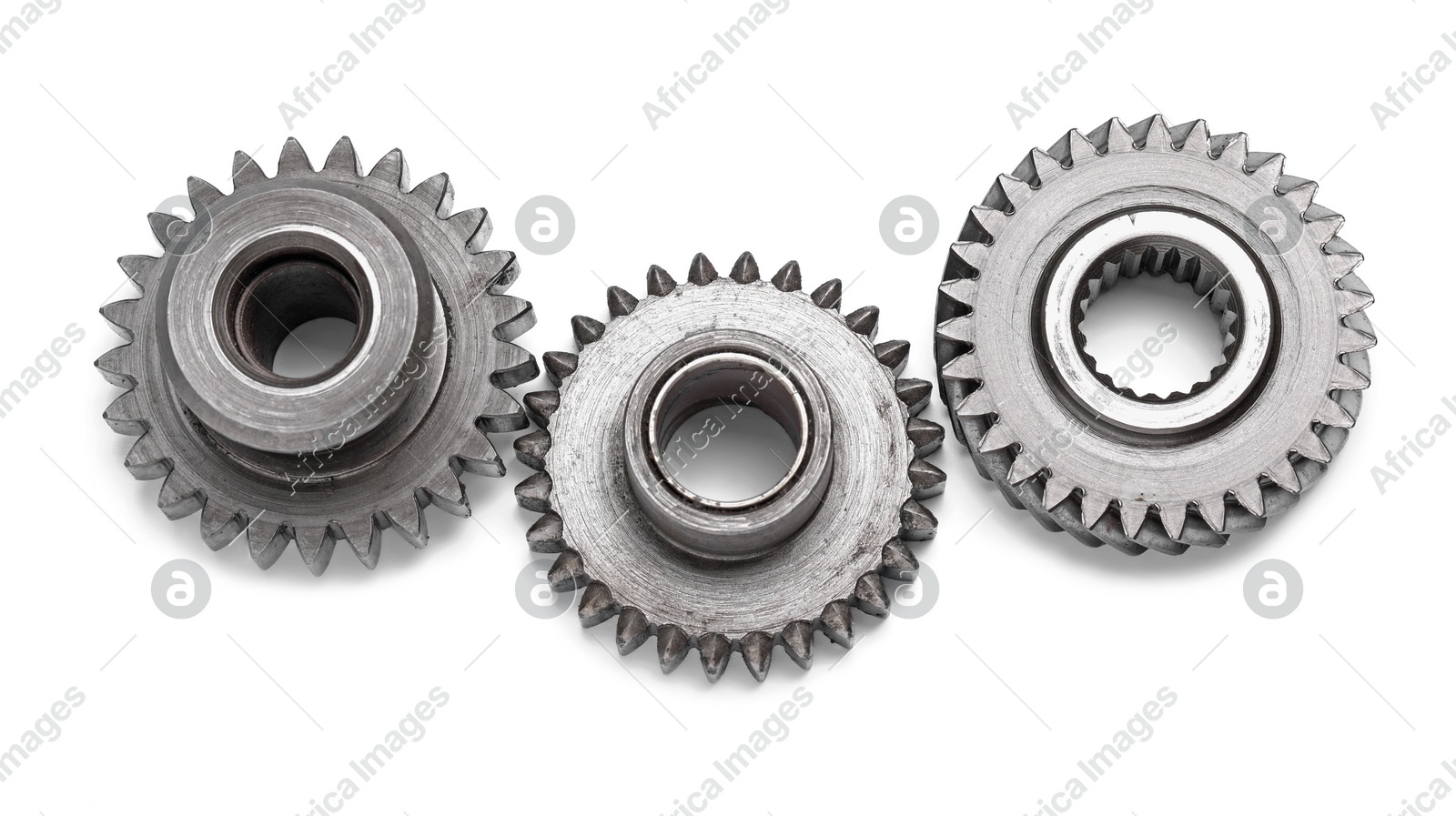 Different stainless steel gears on white background Photo of Different stainless steel gears on white background