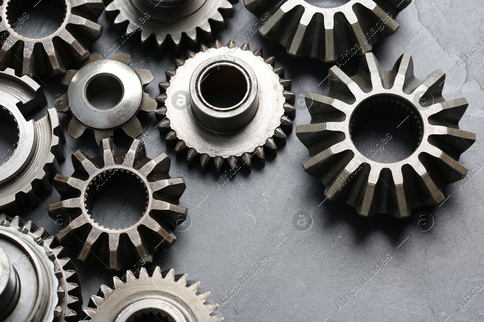 Different stainless steel gears on light grey background, above view Photo of Different stainless steel gears on light grey background, above view