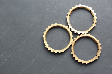 Stainless steel gears on grey background, flat lay. Space for text Photo of Stainless steel gears on grey background, flat lay. Space for text