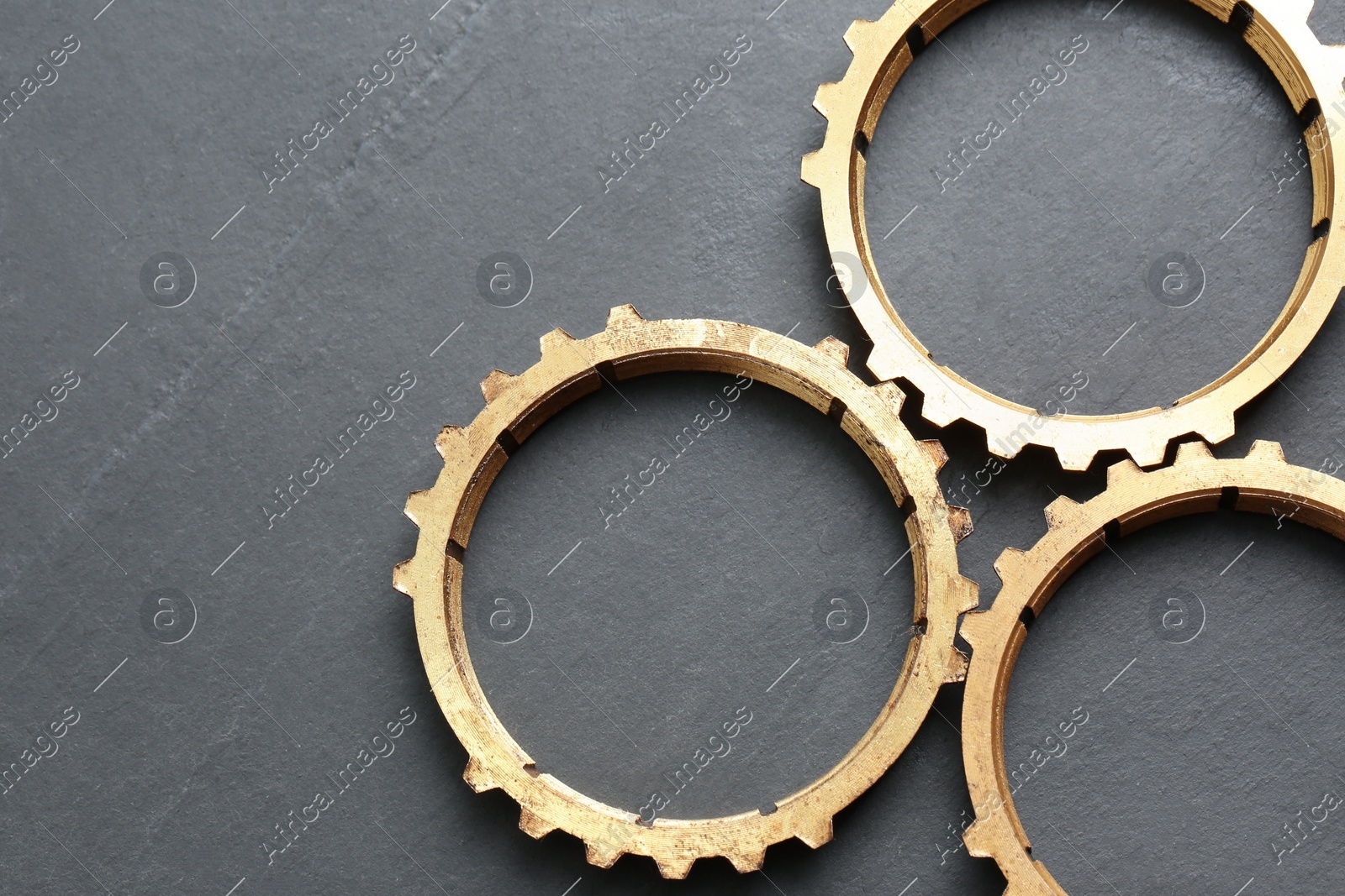 Stainless steel gears on grey background, flat lay. Space for text Photo of Stainless steel gears on grey background, flat lay. Space for text