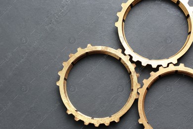 Stainless steel gears on grey background, flat lay. Space for text Photo of Stainless steel gears on grey background, flat lay. Space for text