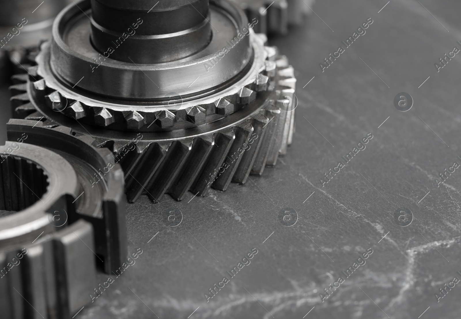 Different stainless steel gears on grey background, closeup. Space for text Photo of Different stainless steel gears on grey background, closeup. Space for text