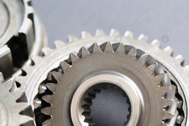 Many different stainless steel gears on grey background, closeup Photo of Many different stainless steel gears on grey background, closeup